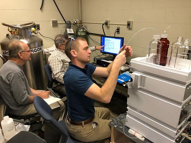 Photo of researchers using lab equipment