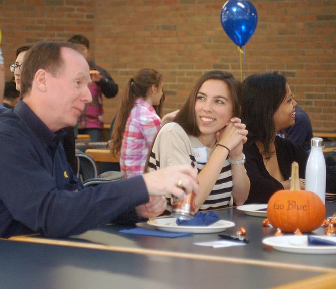 A photo of an alumnus and student at a CEEFA event