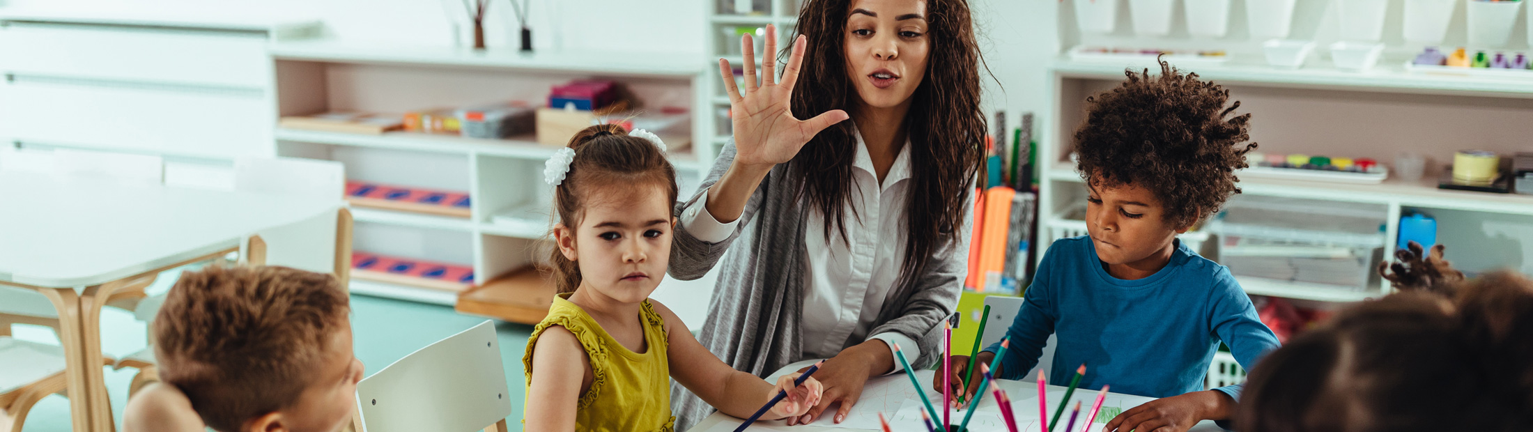 Children and a teacher in a classroom.