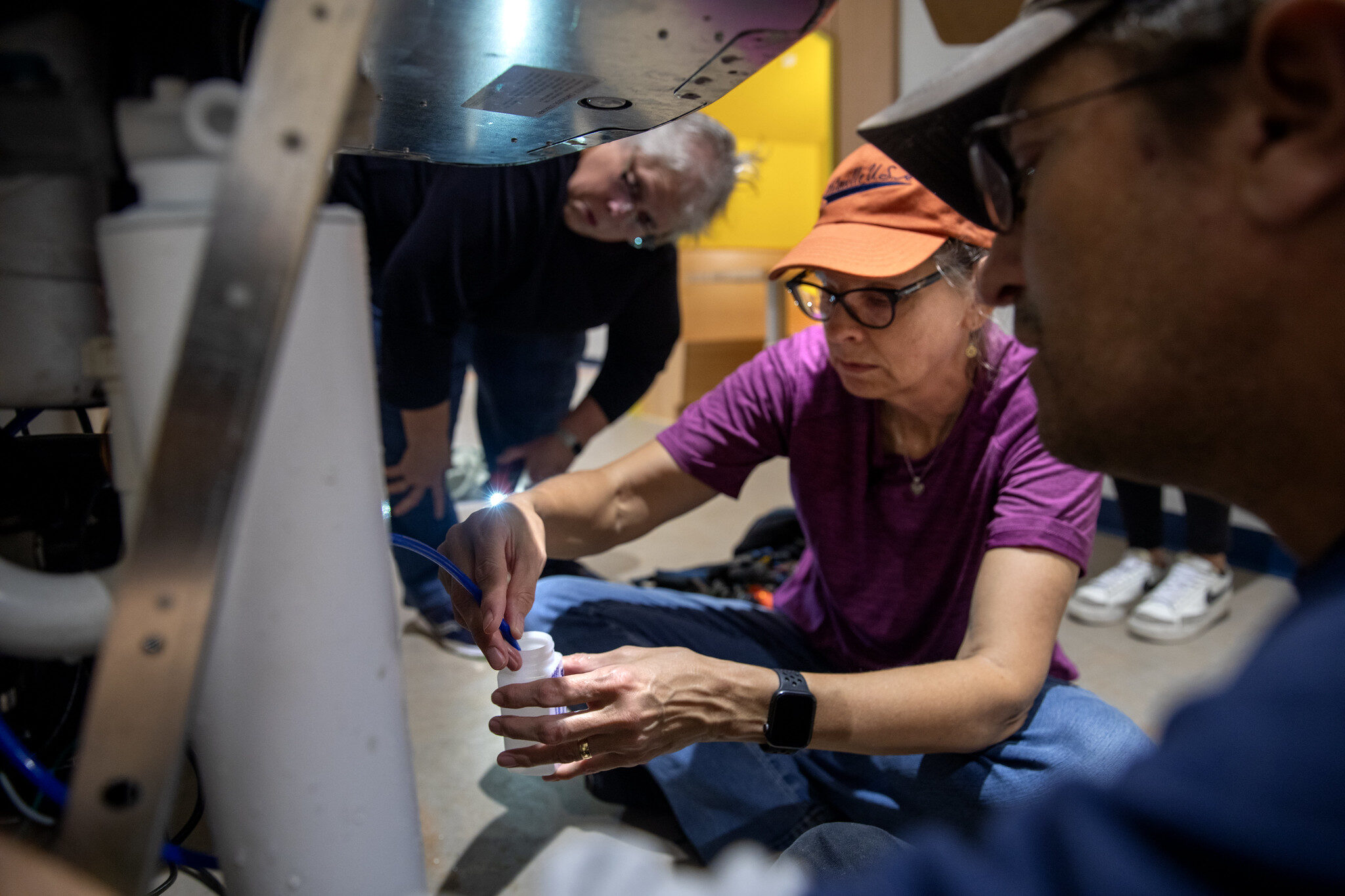 Nancy Love, University of Michigan Civil and Environmental Engineering Professor samples water coming into drinking fountains and coming out of the drinking fountains in Flint public schools, including Doyle-Ryder Elementary school. Love is assisted by UM engineering student Josefia Frydenborg and plumber Lee Dyson. Laura Sullivan, Professor of Mechanical Engineering at Kettering University is also collaborating with Love. Image credit: Marcin Szczepanski, Michigan Engineering